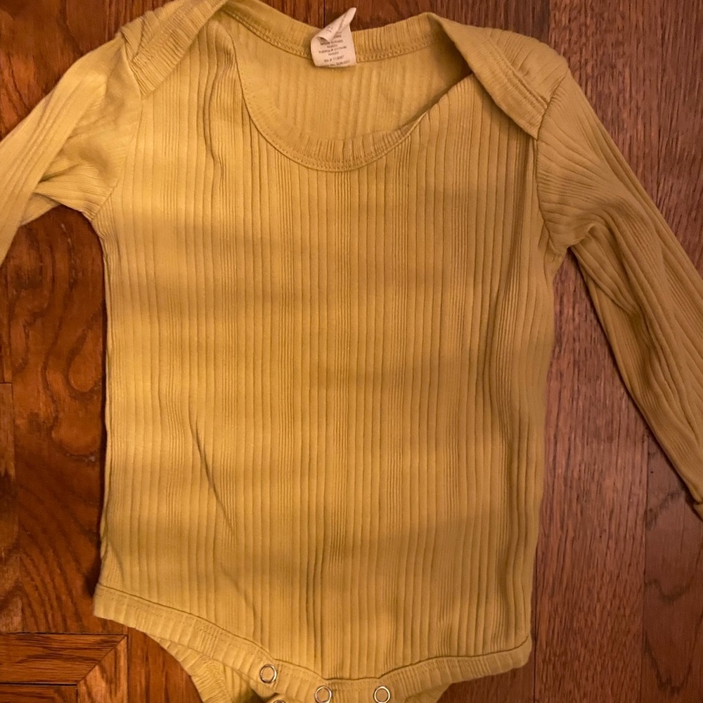 Kate Quinn mustard color onesie